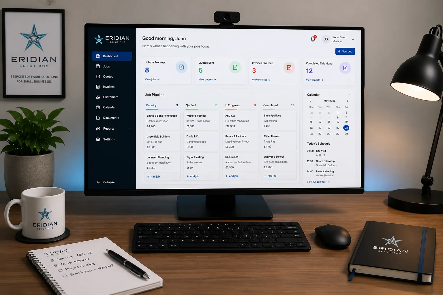 A tidy desk showing a custom Eridian Solutions dashboard on one monitor